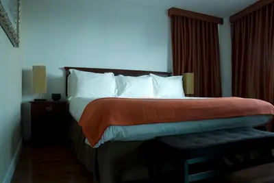 a bedroom with a bed with a red blanket on it at The Fritz Hotel in Miami Beach