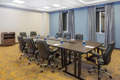 a conference room with a long table and chairs at Wingate by Wyndham Miami Airport in Miami