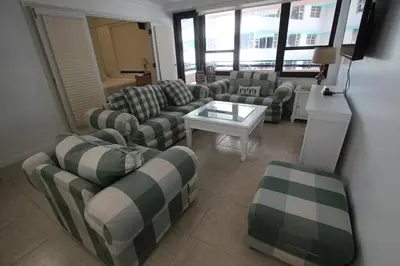 a living room with couches and a table at 2 Bedroom 2 Bath Beachfront Condo on Miami Beach Millionaire Row in Miami Beach