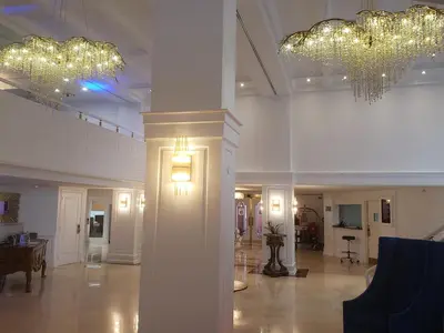 a lobby with two chandeliers and a table in a building at 2 Bedroom 2 Bath Beachfront Condo on Miami Beach Millionaire Row in Miami Beach