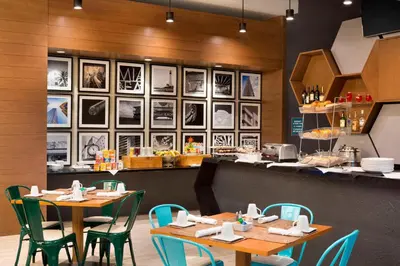 a restaurant with two tables and chairs and a counter at Four Points by Sheraton Miami Airport in Miami