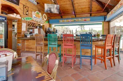 a restaurant with colorful chairs and a bar at Castle Beach: Rumba Suite in Miami Beach
