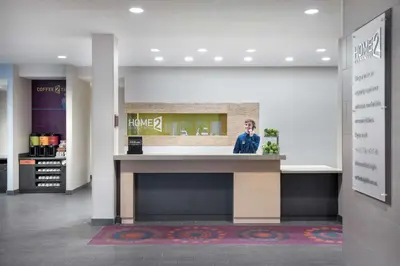 a woman standing at a counter in a store at Home2 Suites By Hilton Ft. Lauderdale Airport-Cruise Port in Dania Beach