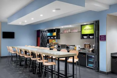 a large dining room with a long table and chairs at Home2 Suites By Hilton Ft. Lauderdale Airport-Cruise Port in Dania Beach