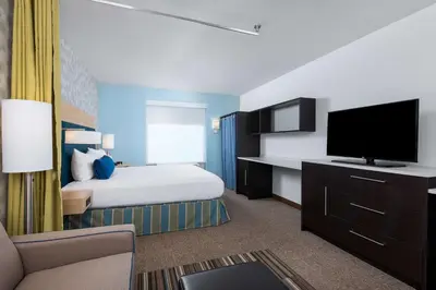 a hotel room with a bed and a flat screen tv at Home2 Suites By Hilton Ft. Lauderdale Airport-Cruise Port in Dania Beach