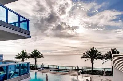a view of the ocean from the balcony of a house at Bluebird Suites Monte Carlo Miami Beach in Miami Beach