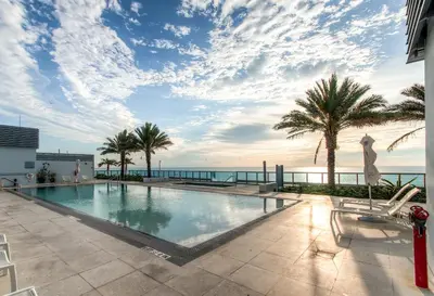 a swimming pool with a view of the ocean at Bluebird Suites Monte Carlo Miami Beach in Miami Beach