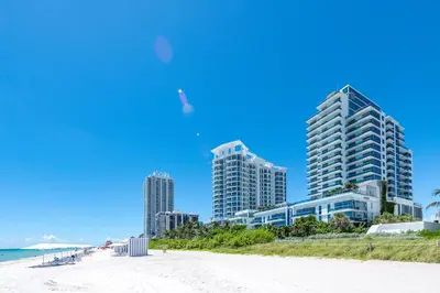 a view of the beach in front of buildings at Bluebird Suites Monte Carlo Miami Beach in Miami Beach