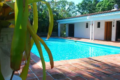 a swimming pool next to a house with a plant at La Finca in Miami