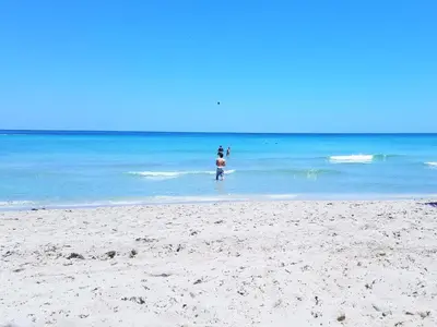 two people standing in the water at the beach at On The Beach - Lux 2 Bedroom Miami in Hollywood