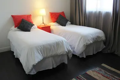 two beds with white and red pillows in a room at On The Beach - Lux 2 Bedroom Miami in Hollywood