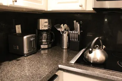 a kitchen counter with a tea kettle on a stove at On The Beach - Lux 2 Bedroom Miami in Hollywood