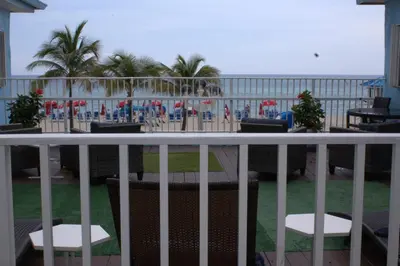 a balcony with a table and chairs and the ocean at Golden Sand Oceanfront in Hollywood