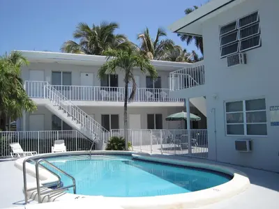 a swimming pool in front of a building at Summerland Suites in Fort Lauderdale