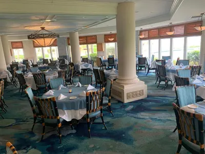 a banquet hall with tables and chairs and windows at The Lago Mar Beach Resort and Club in Fort Lauderdale