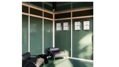 a room with chairs and clocks on the wall at Perroquet Hotel in Fort Lauderdale