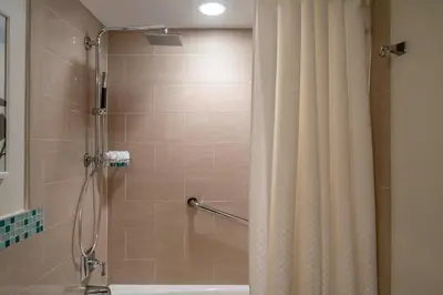 a bathroom with a shower with a shower curtain at The Westin Fort Lauderdale Beach Resort in Fort Lauderdale