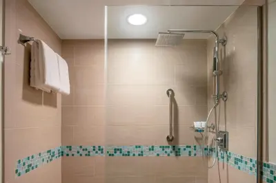 a bathroom with a shower with a glass door at The Westin Fort Lauderdale Beach Resort in Fort Lauderdale