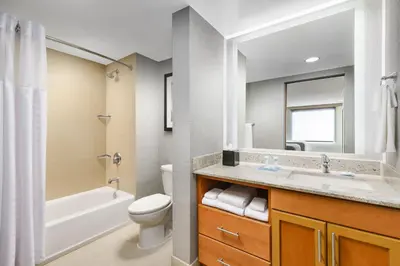 a bathroom with a sink and a toilet and a bath tub at Hyatt House Fort Lauderdale Airport/Cruise Port in Dania Beach