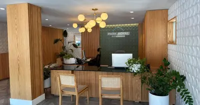 a lobby with a counter with chairs and a desk at Park Royal Miami Beach in Miami Beach