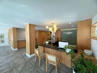 an office lobby with a reception desk and chairs at Park Royal Miami Beach in Miami Beach
