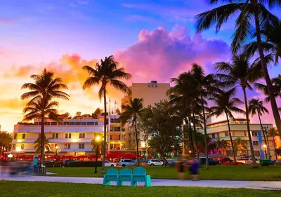 a building with palm trees and chairs in front of it at Park Royal Miami Beach in Miami Beach