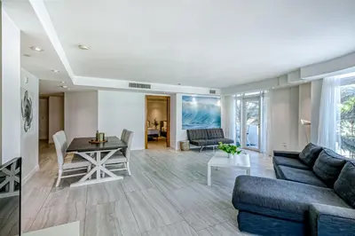 a living room with a couch and a table at Modern Ocean Drive Condo in the Heart of Sobe! in Miami Beach