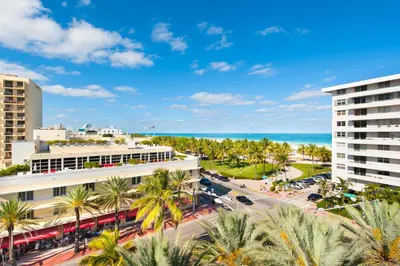 an aerial view of a city with palm trees and the ocean at Modern Ocean Drive Condo in the Heart of Sobe! in Miami Beach