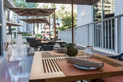 a wooden table with a pineapple on it on a patio at Iberostar Waves Berkeley Shore in Miami Beach