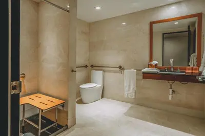 a bathroom with a toilet and a sink at Iberostar Waves Berkeley Shore in Miami Beach