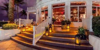 a building with stairs and lights in front of it at Pelican Grand Beach Resort, a Noble House Resort in Fort Lauderdale