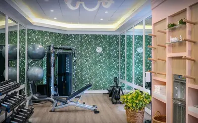 a room with a gym with exercise equipment in it at Pelican Grand Beach Resort, a Noble House Resort in Fort Lauderdale