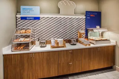 a bakery with a counter with donuts on it at Holiday Inn Express and Suites Fort Lauderdale Airport West by IHG in Davie