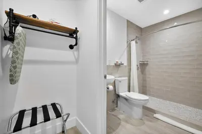 a white bathroom with a toilet and a shower at The New Yorker Hotel Miami in Miami