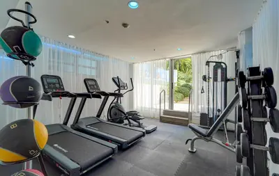 a gym with two treadmills and two tread machines at The Sagamore Hotel South Beach in Miami Beach