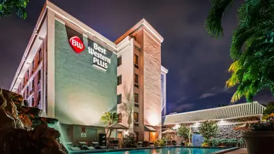 a hotel with a pool at night at Best Western Plus Hollywood/Aventura in Hollywood
