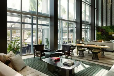 a living room with a couch and a table at Kimpton EPIC Hotel by IHG in Miami