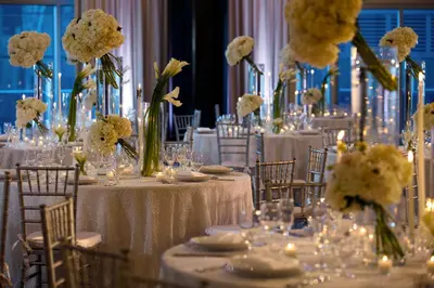 a group of tables with white flowers on them at Kimpton EPIC Hotel by IHG in Miami