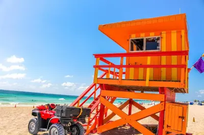 an orange lifeguard tower sitting on the beach at Apartment On The Beach in Miami Beach