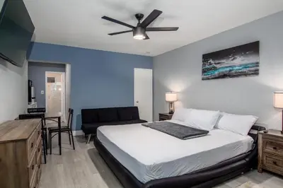 a bedroom with a bed and a ceiling fan at Pousada Suites at Hollywood Beach in Hollywood