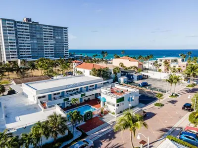 an aerial view of a city with palm trees and the ocean at Pousada Suites at Hollywood Beach in Hollywood