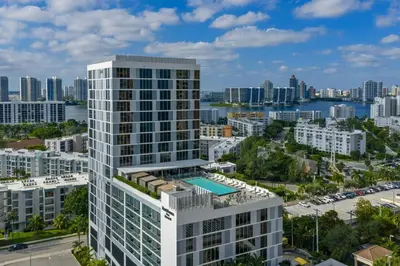 an aerial view of a tall white building with a city at Residence Inn Miami Sunny Isles Beach in Miami Beach