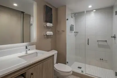 a bathroom with a shower and a toilet and a sink at Residence Inn Miami Sunny Isles Beach in Miami Beach