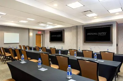 a conference room with tables and chairs and water bottles at SpringHill Suites by Marriott Miami Airport South Blue Lagoon Area in Miami