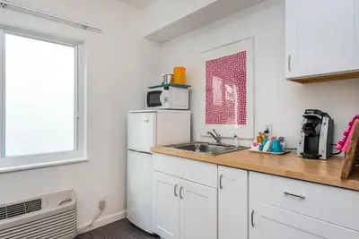 a kitchen with a white refrigerator and a sink at Nobleton Hotel in Fort Lauderdale