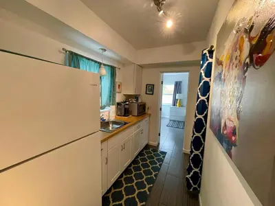 a kitchen with a refrigerator and a sink at Nobleton Hotel in Fort Lauderdale