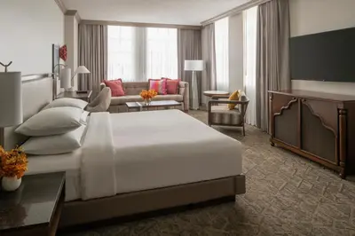 a hotel room with a large bed and a living room at Hyatt Regency Coral Gables in Miami in Miami