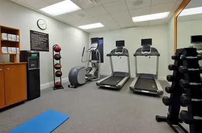 a gym with treadmills and ellipticals in a room at Homewood Suites by Hilton Miami - Airport West in Miami