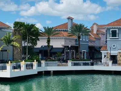 a bridge over a body of water with buildings at The Palms Inn & Suites Miami, Kendall, FL in Kendall