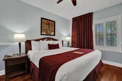 a bedroom with a large bed in a hotel room at The Grand Resort and Spa & Worthington All Male in Fort Lauderdale